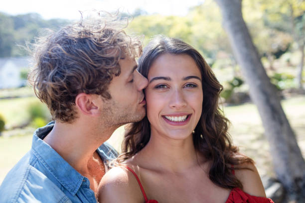 istock Man kissing woman on cheek 649911892