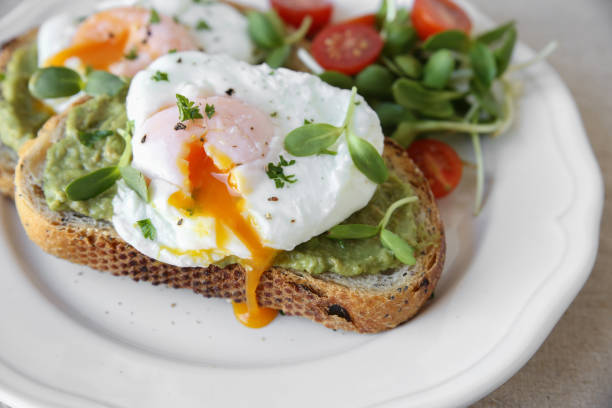 istock Poached eggs with avocado,tomato and sunflower sprout on sourdough toasts 649912842