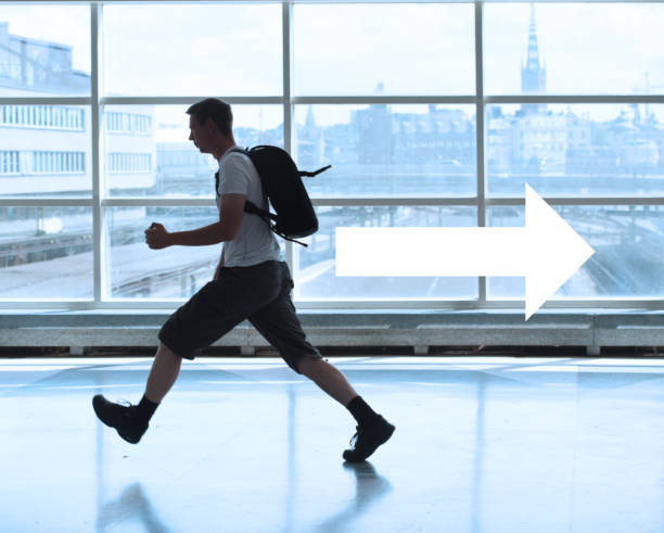 istock Man walking running fast against profile arrow direction 649920088