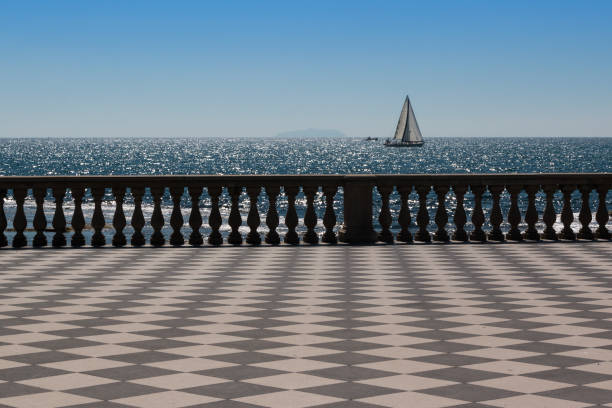 Livorno' s Mascagni Terrace and White Sailing Boat in Background, Tuscany - Italy Livorno' s Mascagni Terrace and White Sailing Boat in Background, Tuscany - Italy livorno stock pictures, royalty-free photos & images