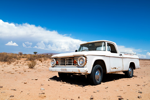 A rusty, abandoned, vintage American truck in the desert, Namibia.