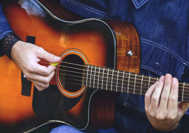 istock Man playing acoustic guitar 649951860