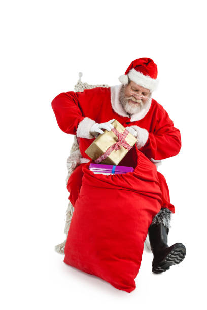 istock Santa claus putting presents in christmas bag 649960128