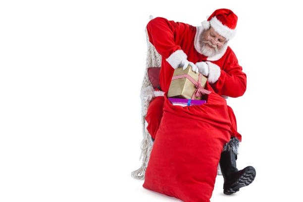 istock Santa claus putting presents in christmas bag 649960170