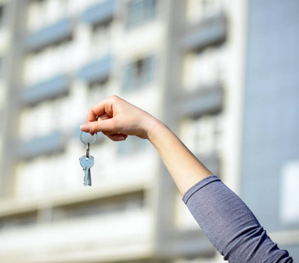 istock Woman's hand holding keys to new home 649963480