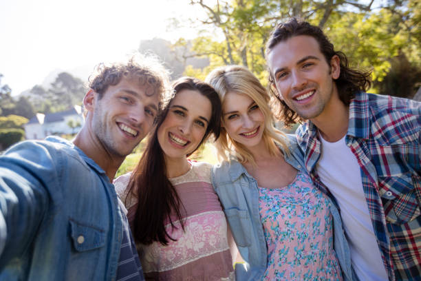 istock Friends standing together in park 649976256