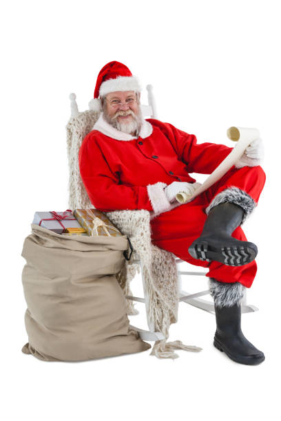 istock Happy santa claus holding a scroll 649984104