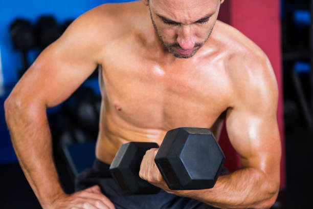 istock Male athlete holding dumbbell 649986502