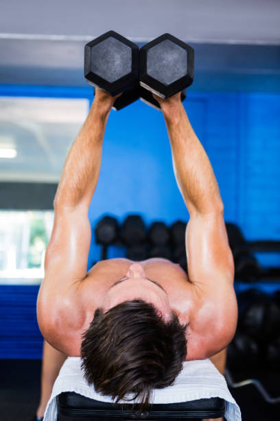 istock Shirtless man lifting dumbbell 649986618