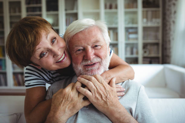 istock Senior woman embracing man at home 650006952