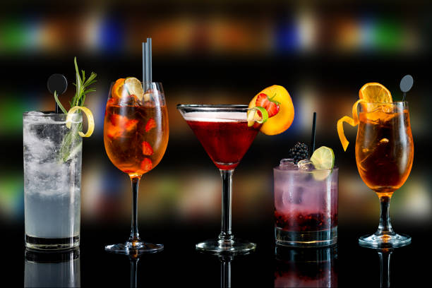 selection of cocktails various cocktail drinks on bar counter with dark background fresh fruit decoration garnish cocktail shaker photos stock pictures, royalty-free photos & images
