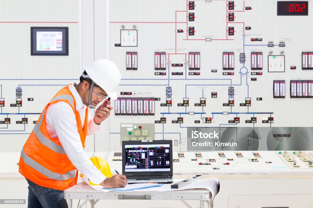 Electrical engineer working at control room of thermal power plant Electrical engineer working at control room of a modern thermal power plant Nuclear Power Station Stock Photo