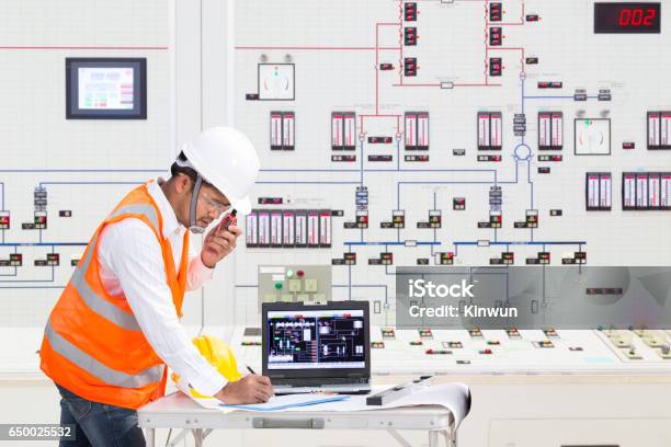 Electrical Engineer Working At Control Room Of Thermal Power Plant Stock Photo - Download Image Now