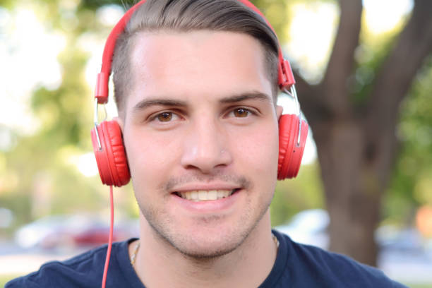 istock Young man with headphones in a park. 650025954