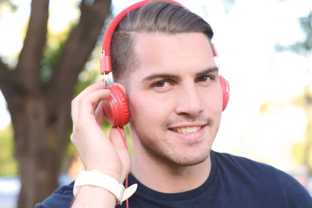 istock Young man with headphones in a park. 650025960