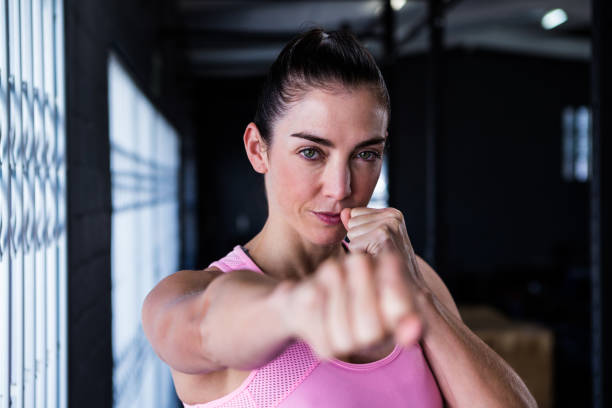 istock Portrait of confident athlete punching 650037398