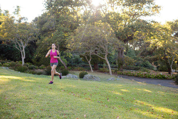Female jogger listening to music while jogging in the park