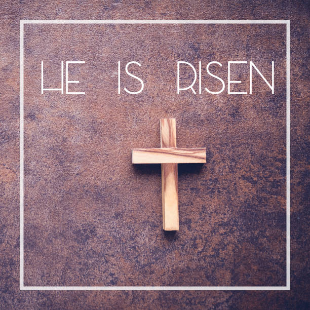 istock He is risen word and wooden cross on dark background 650037658