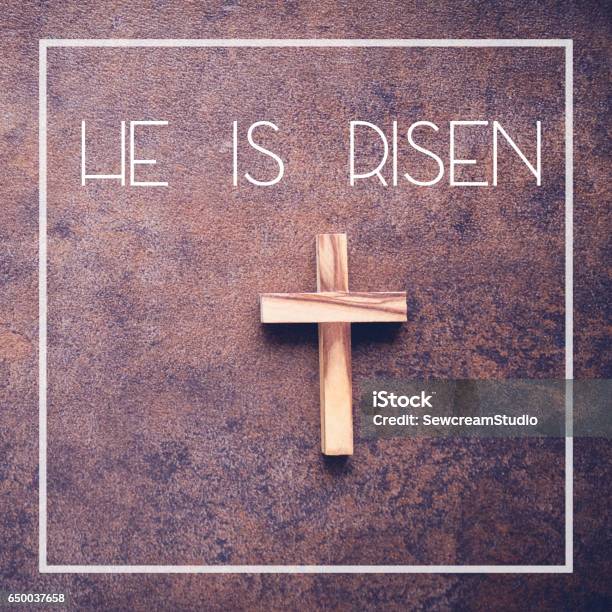 He Is Risen Word And Wooden Cross On Dark Background Stock Photo - Download Image Now