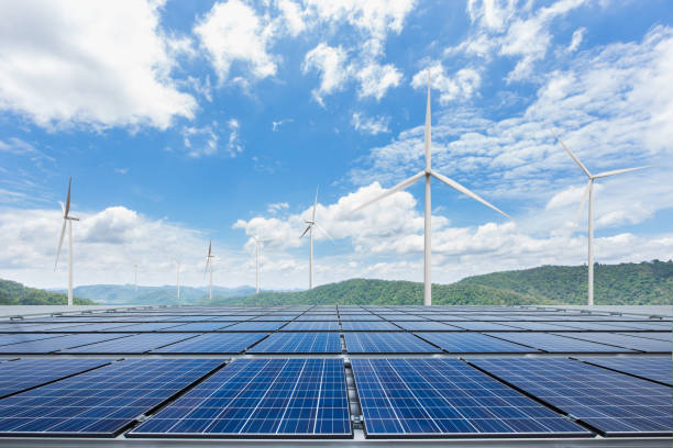 istock Solar panels with wind turbines against mountanis landscape 650037674