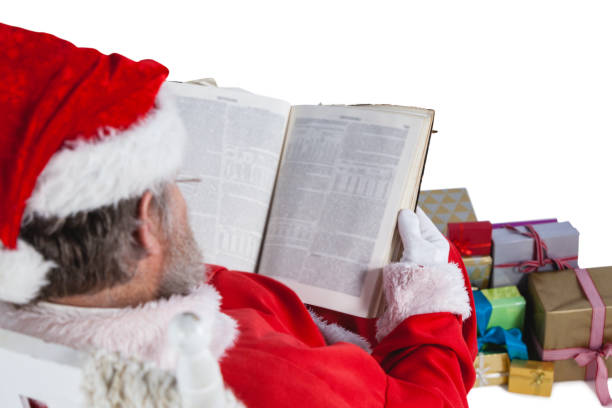 istock Santa claus reading bible with christmas present beside him 650039218