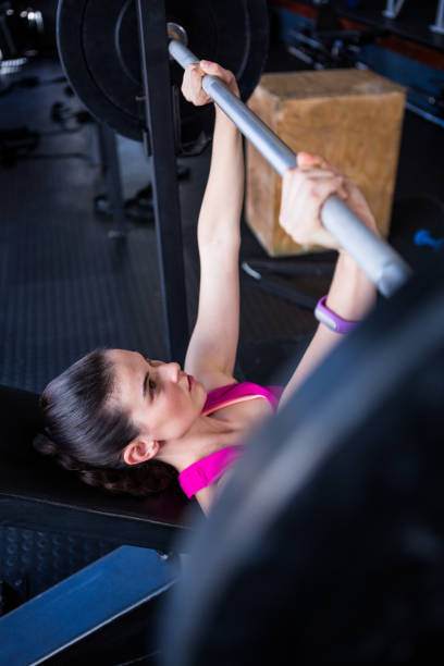 istock Young female athlete lifting barbell 650043796