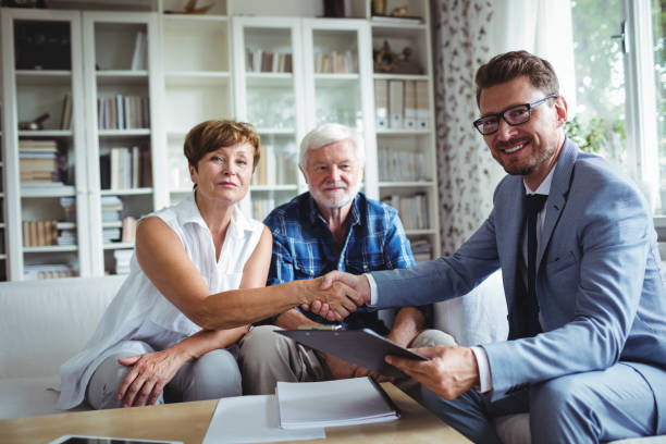 istock Financial advisor shaking hands with senior woman 650045524