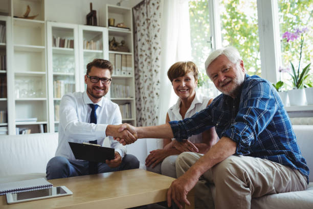 istock Financial advisor shaking hands with senior man 650045982