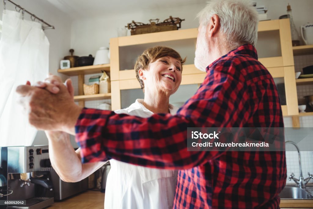 Senior couple dancing Senior couple dancing together in kitchen Dancing Stock Photo