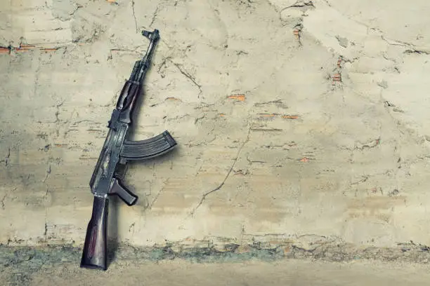 old submachine gun  kalashnikov  AK-47 against the wall