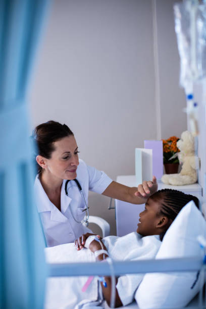 istock Female doctor checking patient fever in ward 650063200