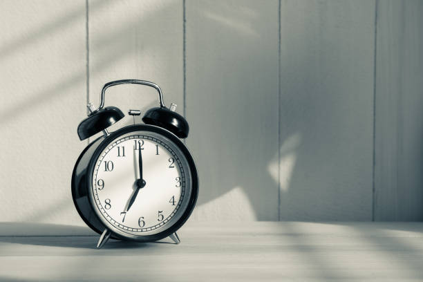 istock Old alarm clock on wooden table 650063550
