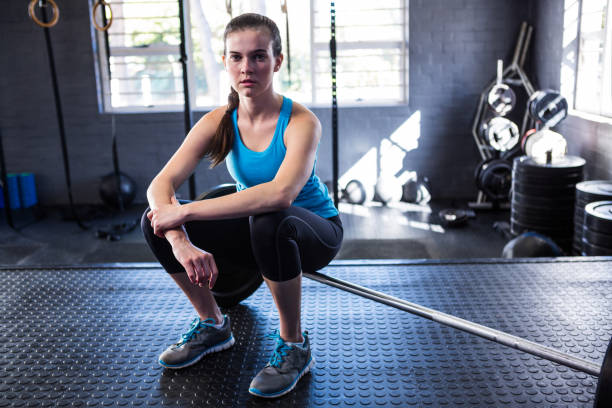istock Confident female athlete sitting on barbell 650064280