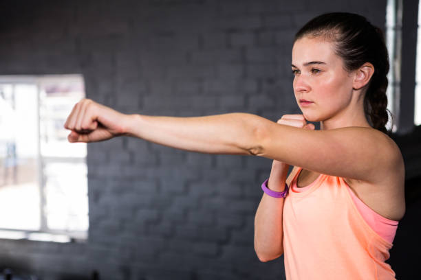 istock Young woman punching in gym 650066772