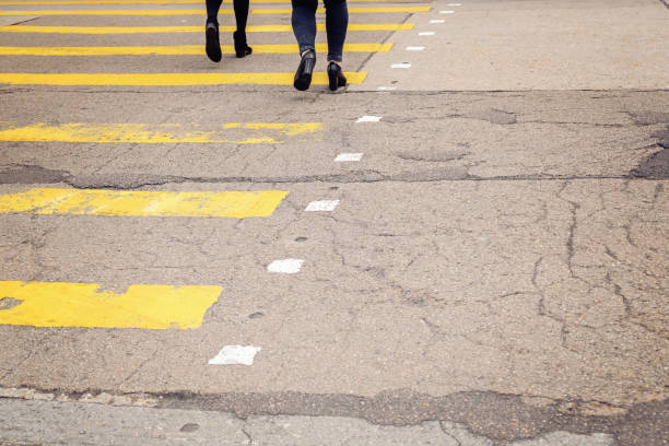 istock yellow crossroad with walking pedestrians, toning 650070202