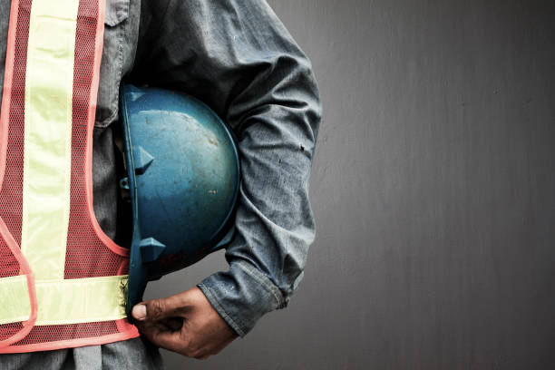 istock Man holding blue helmet close up 650076410
