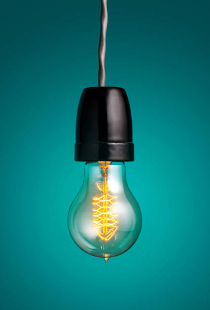 istock antique edison style filament light bulbs hanging light bulb over green background. 650086384