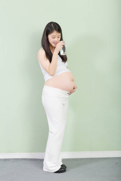 istock young pretty pregnant woman on background 650087148