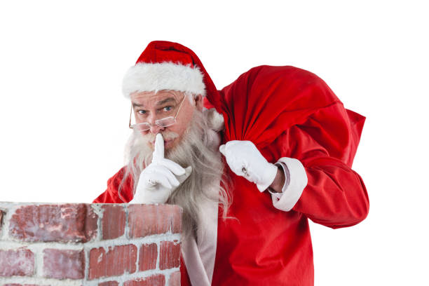Santa claus with finger on lips standing beside chimney Santa claus with finger on lips standing beside chimney against white background santa claus expressions shhh stock pictures, royalty-free photos & images