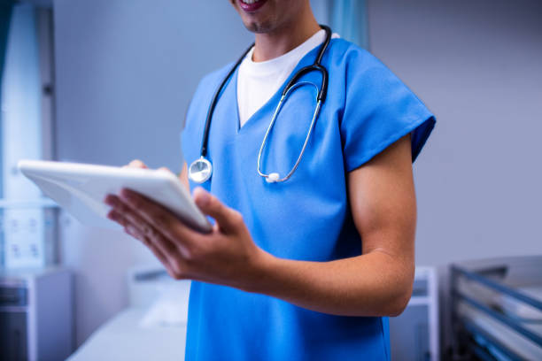 istock Doctor using digital tablet in ward at hospital 650090766