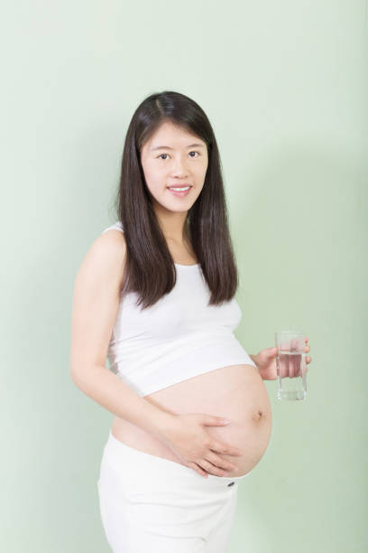istock young pretty pregnant woman on background 650093762
