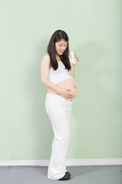istock young pretty pregnant woman on background 650097066