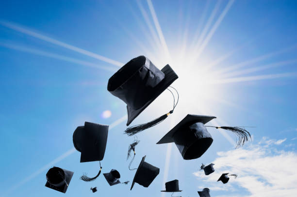 istock Graduation Ceremony, Graduation Caps, hat Thrown in the Air with blue sky abstract background. 650097734