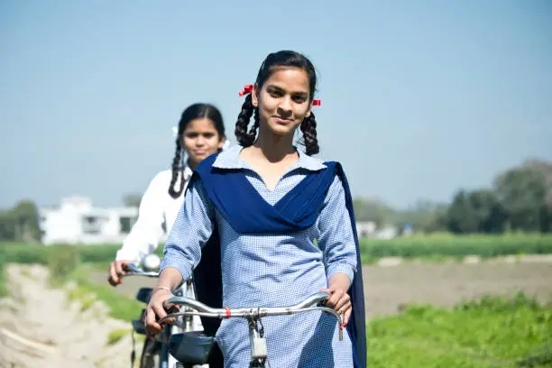 Photo of Indian school girls with bicycle