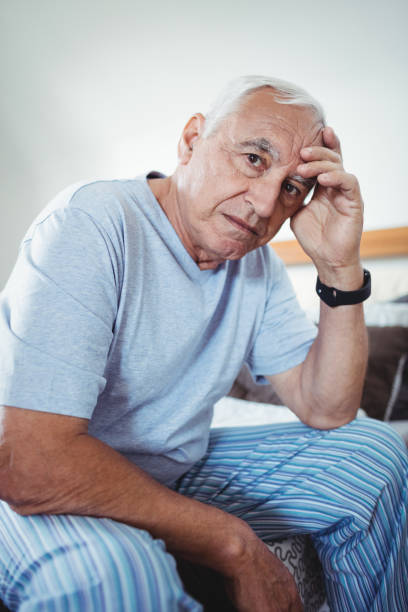 istock Frustrated senior man sitting on bed 650098968