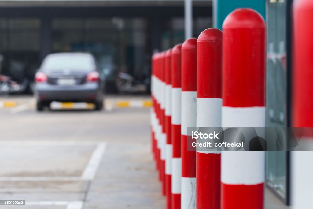 red white stripe pole car parking warning area at fuel gas station. Bollard Stock Photo