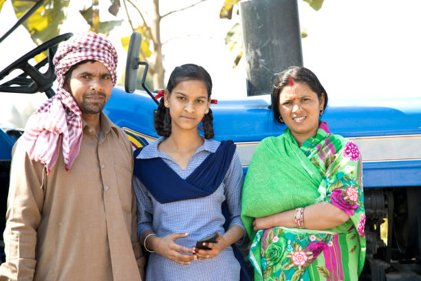 istock Family posing in front of tractor 650110020