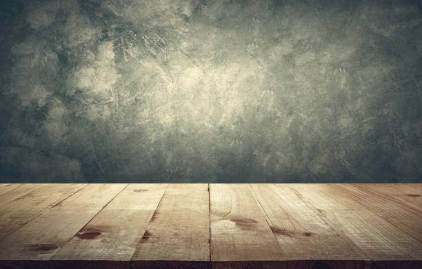 istock Wood table top with vintage grunge cement wall background copy space ready for your product design. 650110520