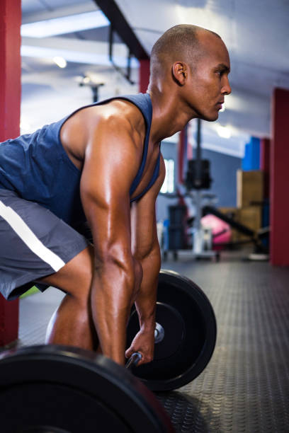 istock Male athlete lifting barbell 650113422
