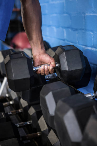 istock Man exercising with dumbbell in gym 650114732